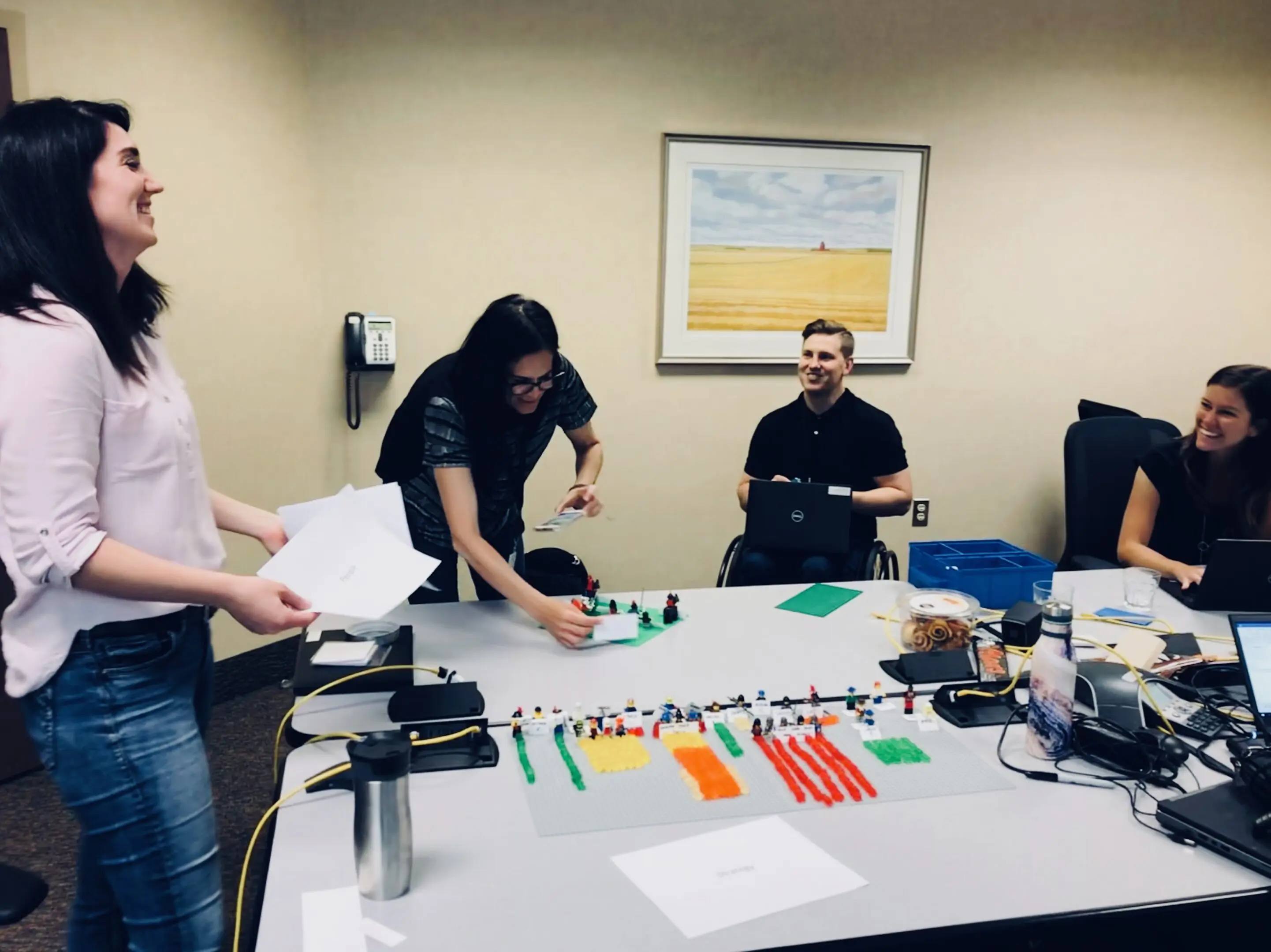 People collaborating around a table with colorful sticky notes and papers.