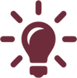 A black silhouette of a light bulb with rays on a maroon background.